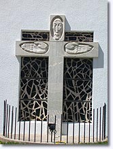 Larche, crucifix on the facade of the church